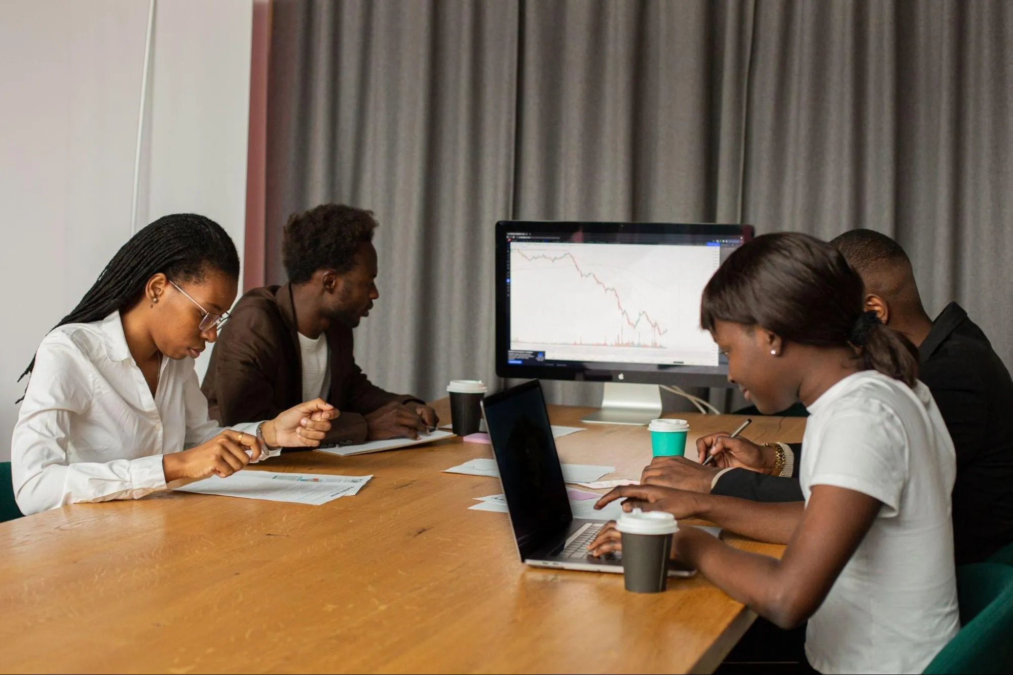 Finance team analyzing financial data on a digital dashboard