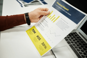 Financial automation report showing business performance charts and financial data on a laptop
