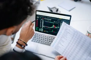 Finance professional reviewing financial data and reports on a laptop during post-go-live finance transformation